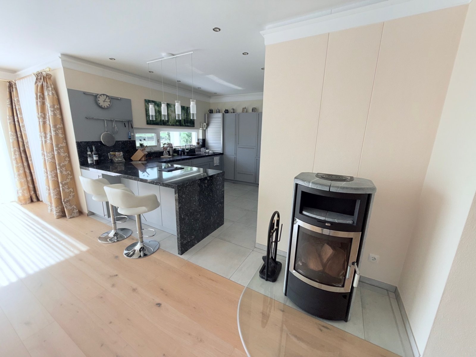 Wohnzimmer mit Küchenansicht und Kaminecke